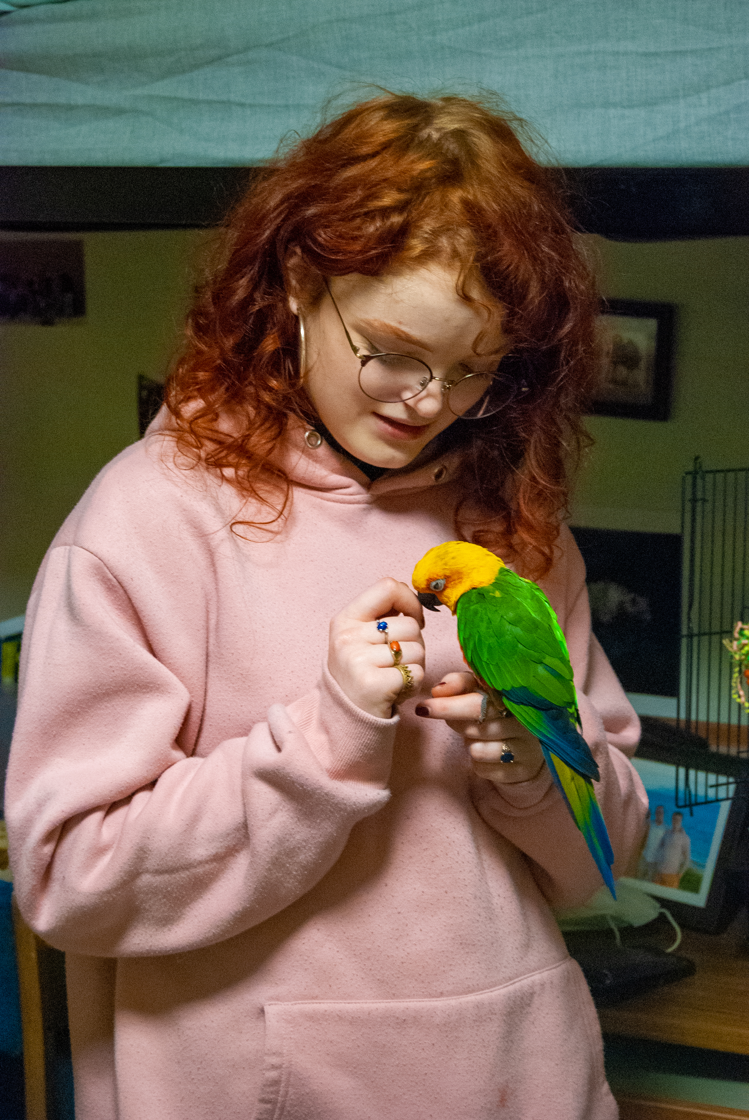 While holding Ollie on her finger, Wade cranes her neck down as Ollie nestles close to her chest.