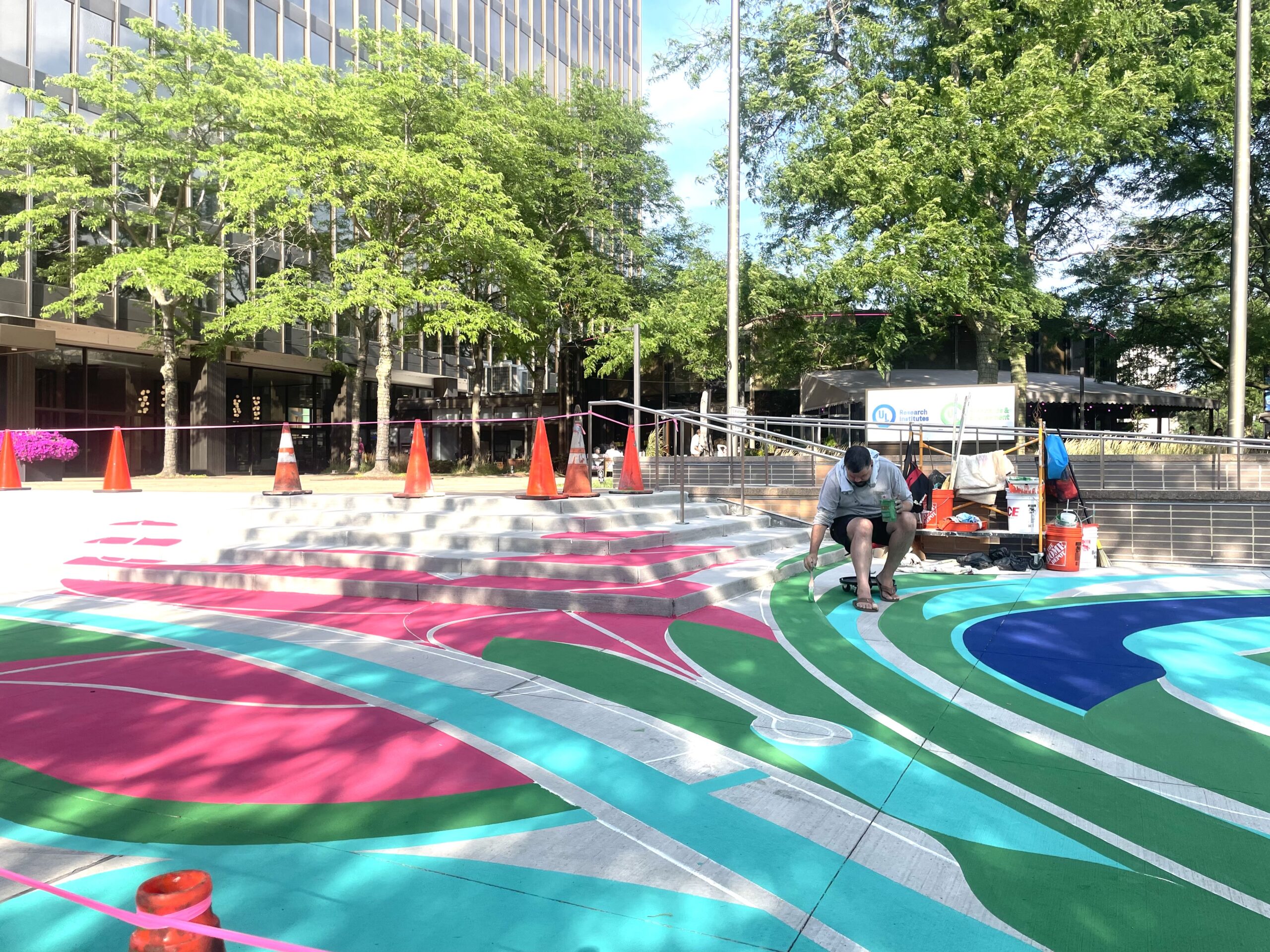 Mural, mural on the asphalt: Street artist paints giant flower on Evanston plaza sidewalk
